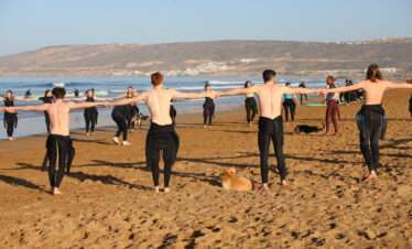 "A group of surfers waiting for the wave, ready to take on the ocean."