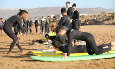 "A group of surfers waiting for the wave, ready to take on the ocean."