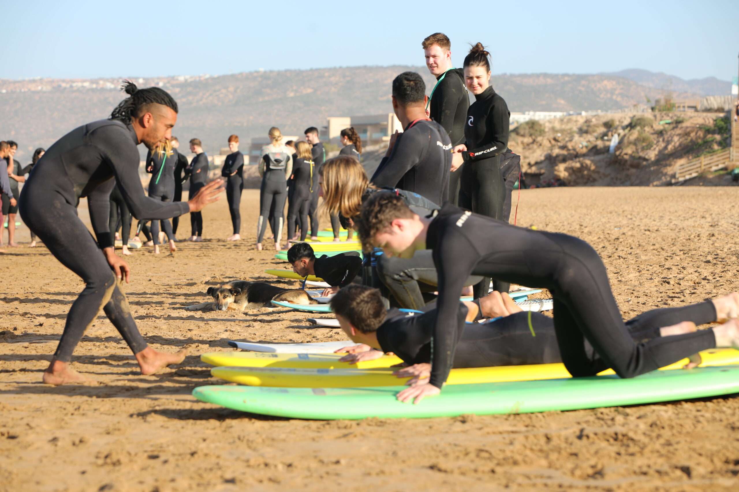 "A group of surfers waiting for the wave, ready to take on the ocean."