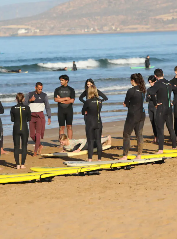 "A group of surfers waiting for the wave, ready to take on the ocean."