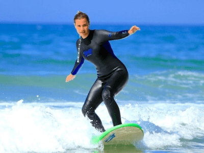 "A girl surfing on a wave."