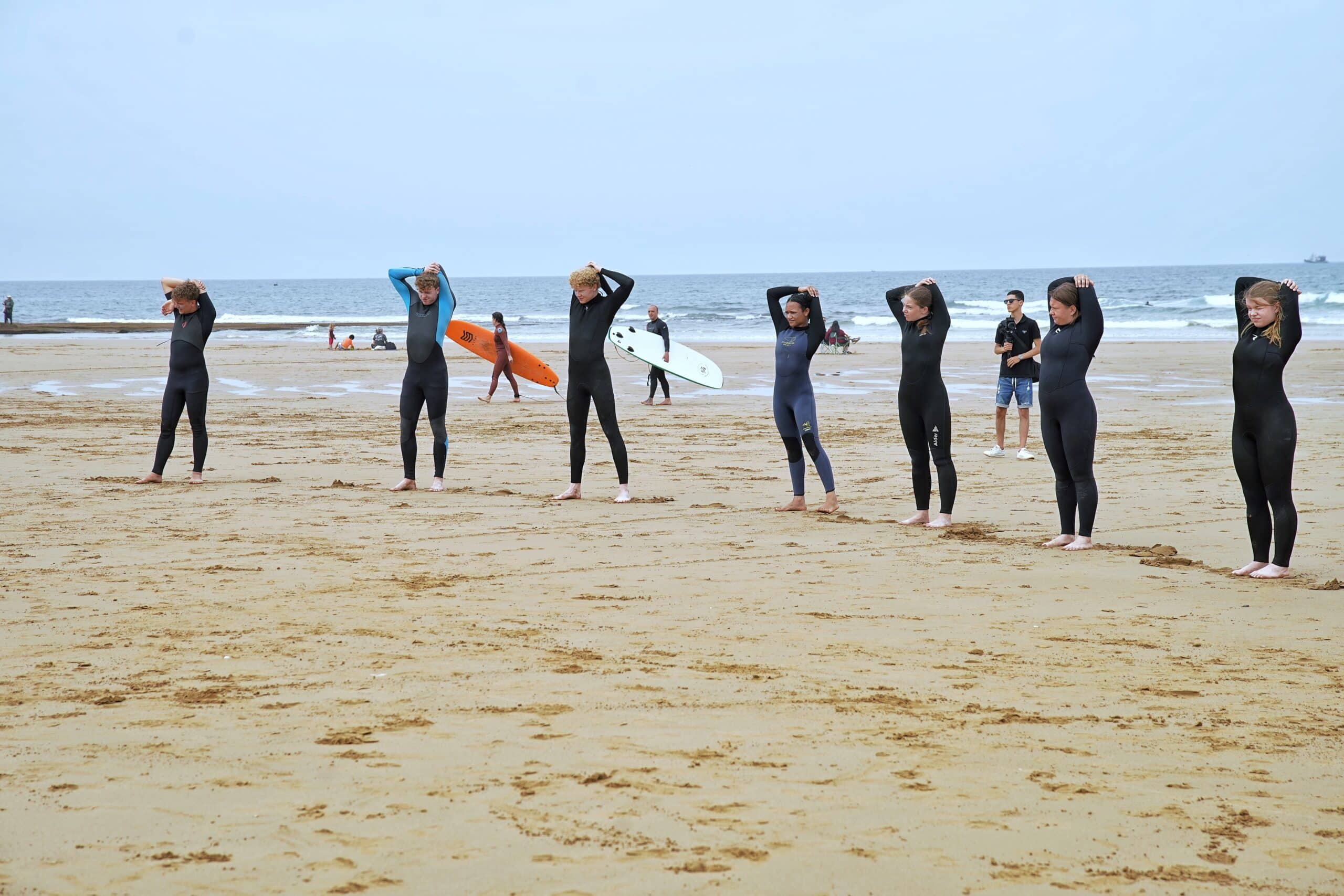 Surf students walking to the beach with boards in Taghazout