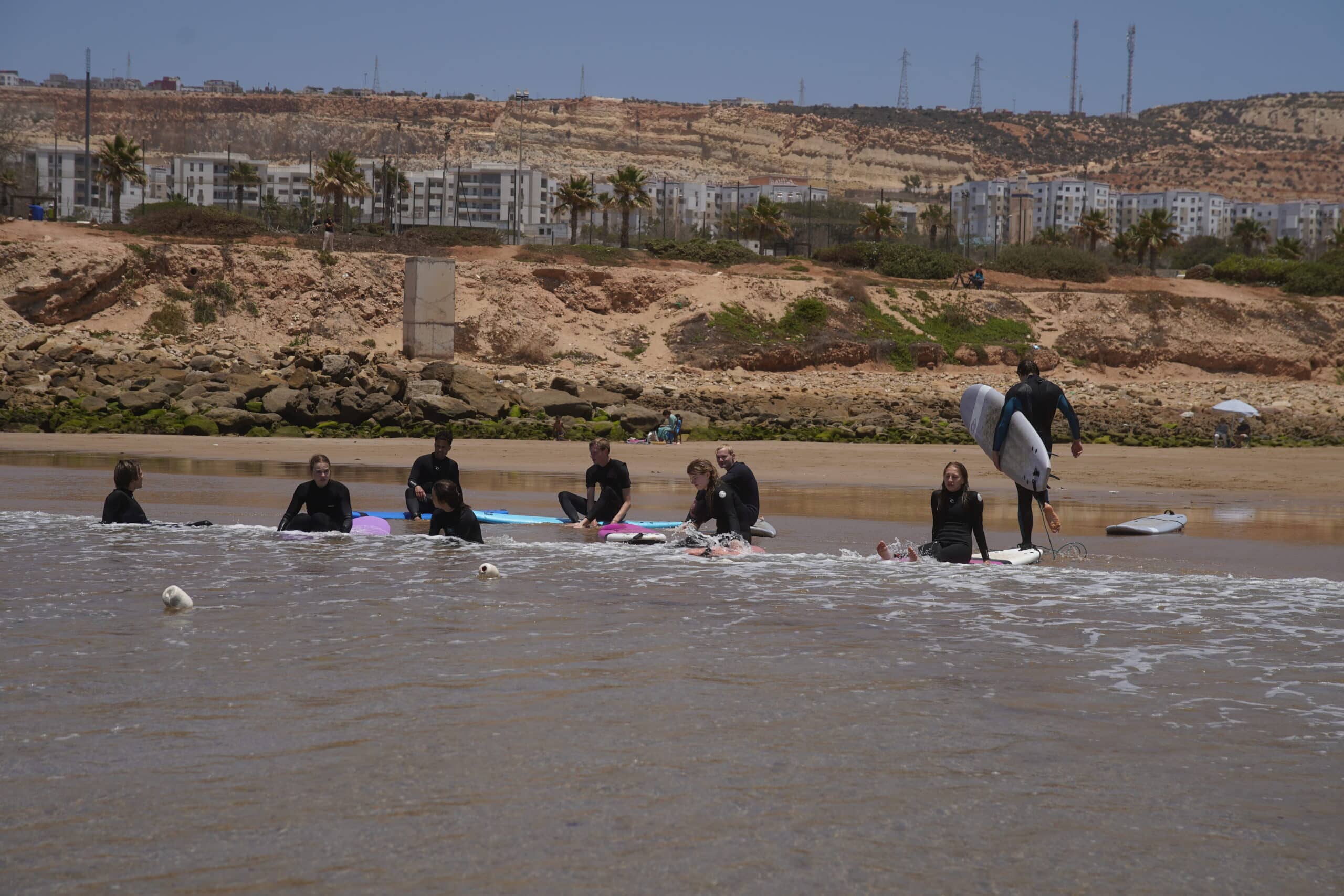 Guests paddling out for a surf session
